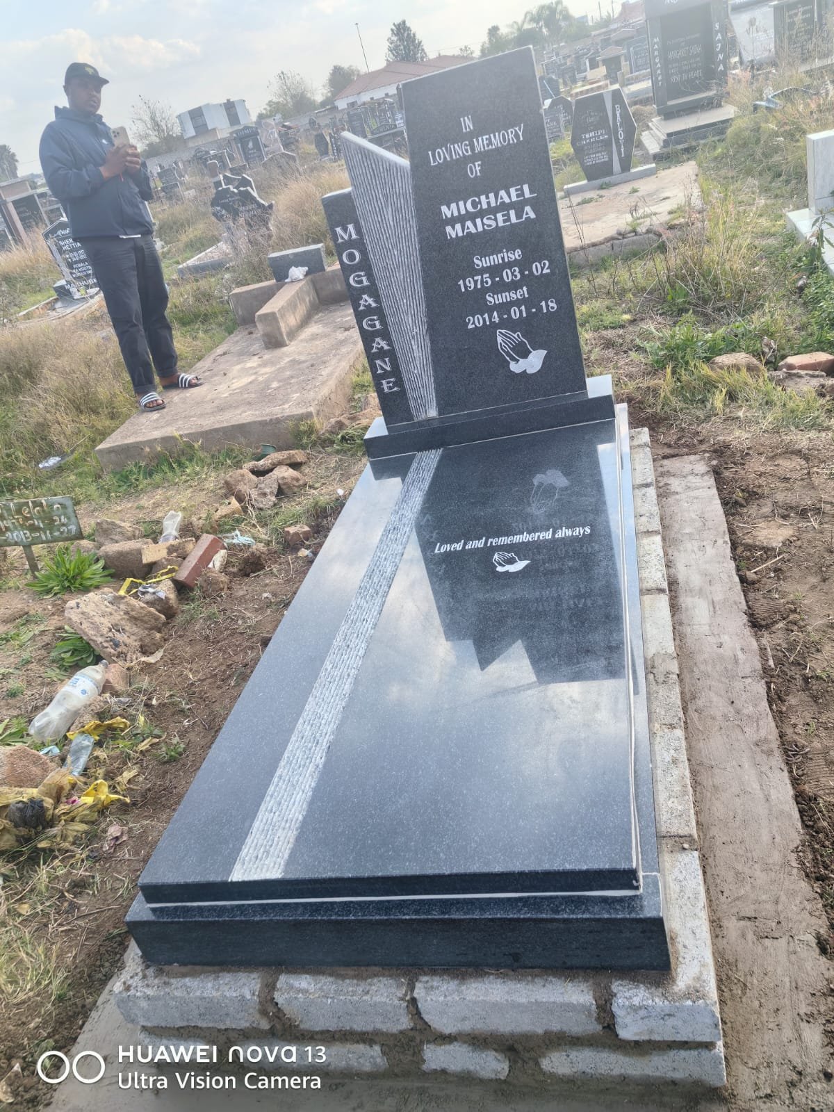 Custom granite memorial with book design and engraved tribute