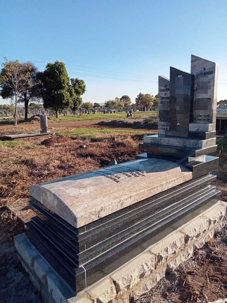 Double granite tombstone for family