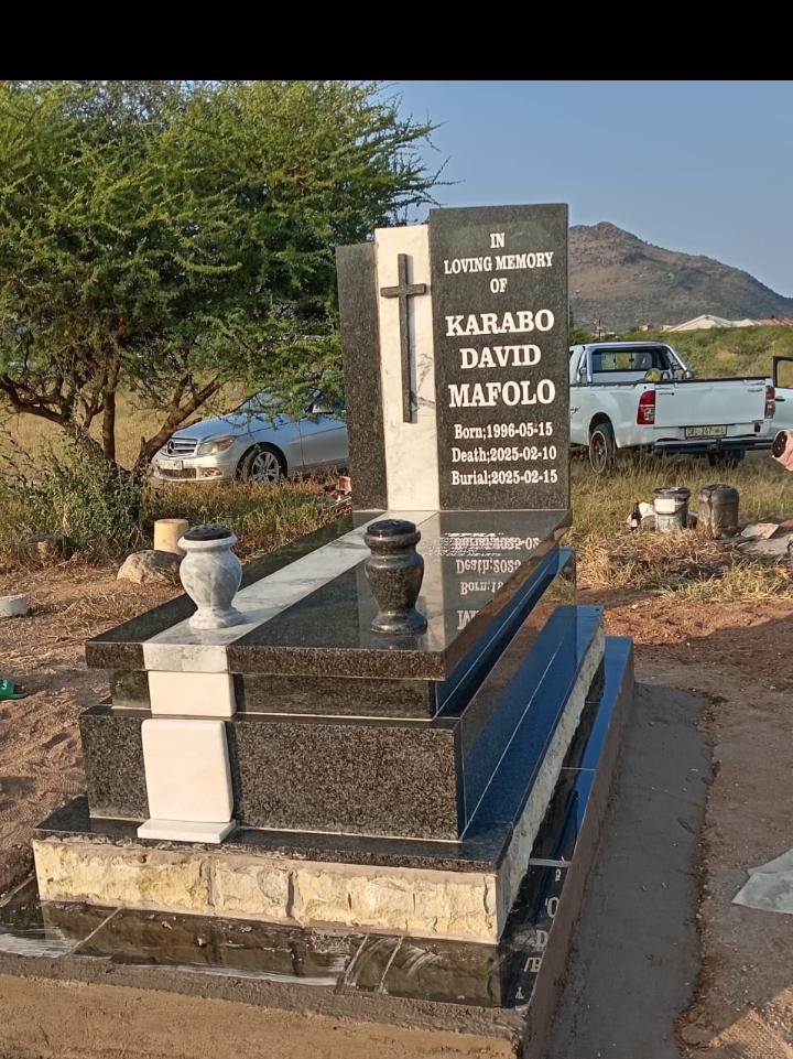 Single tombstone with cross and marble vases